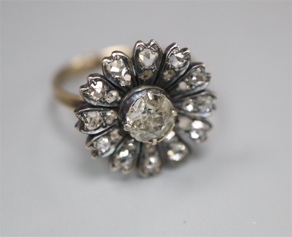 An antique yellow metal and diamond set circular cluster ring, (adapted?), size K/L, gross 3.5 grams,